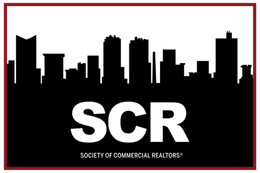 The logo for the society of commercial realtors shows a city skyline.