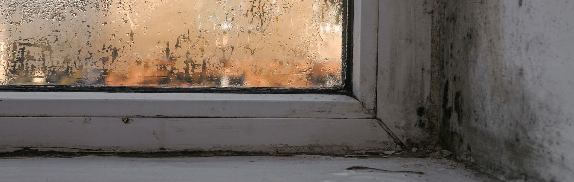 A close up of a window with a lot of condensation on it.