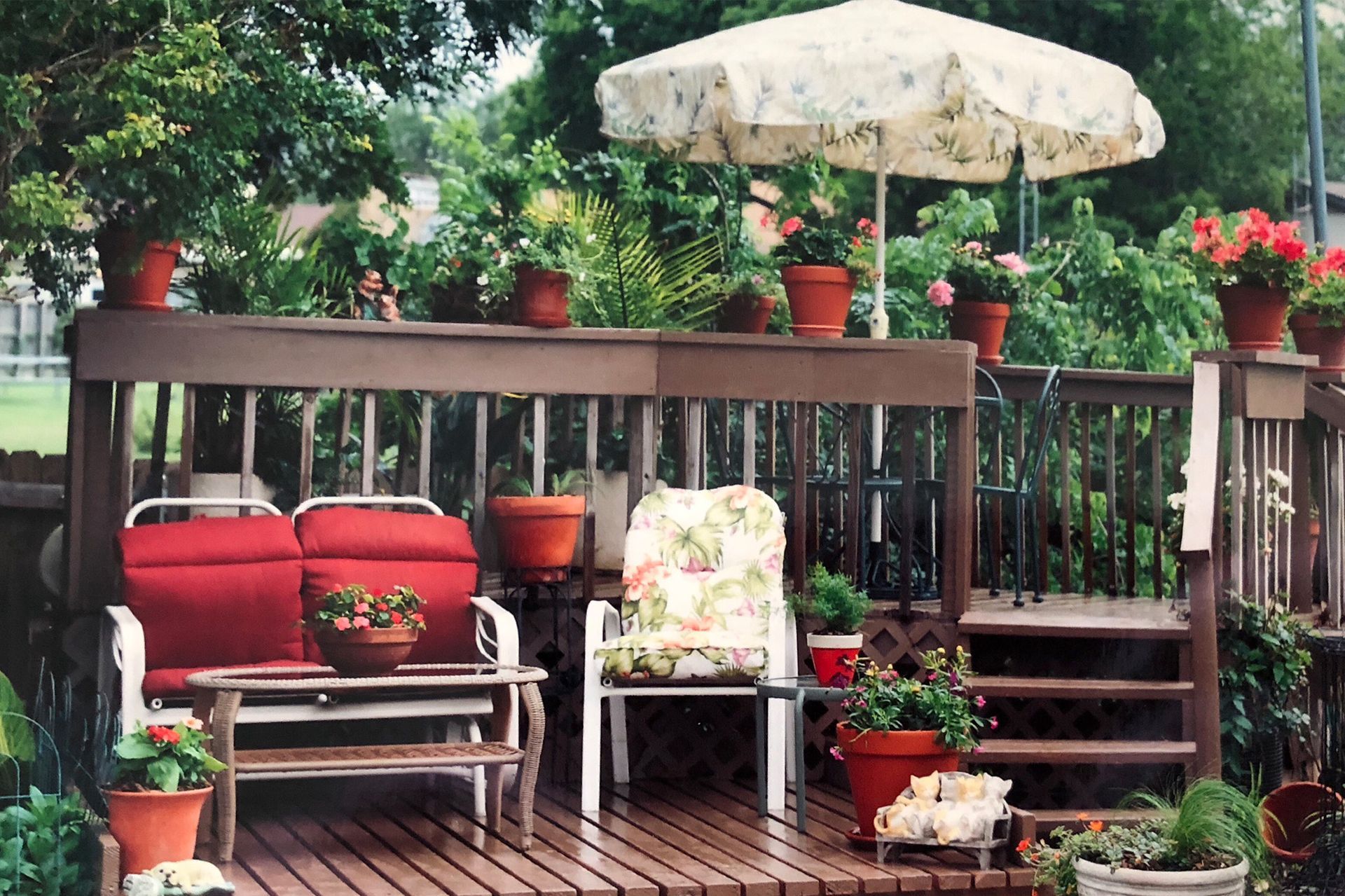 A deck with a couch and chairs under an umbrella