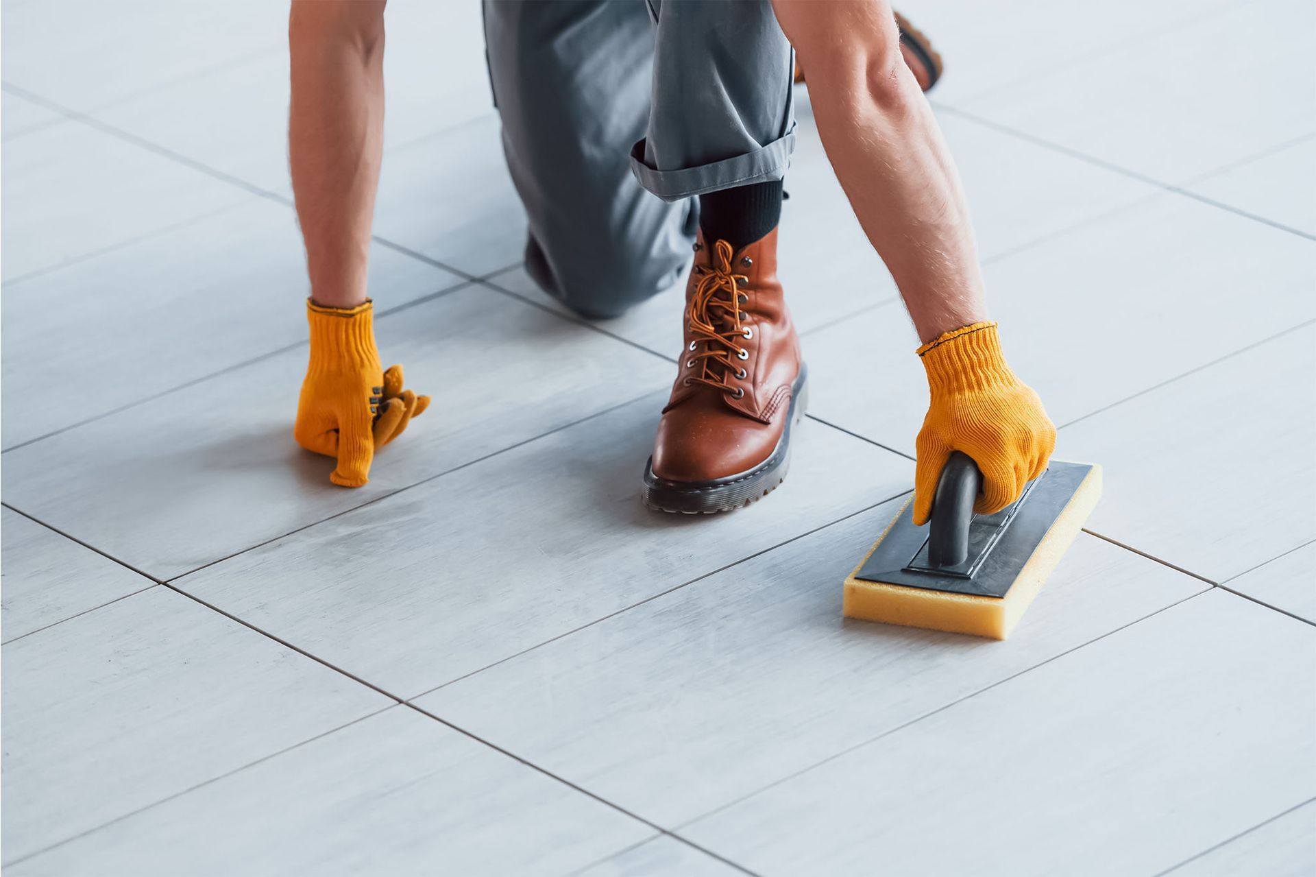 A man is cleaning the floor of an office with a mop.