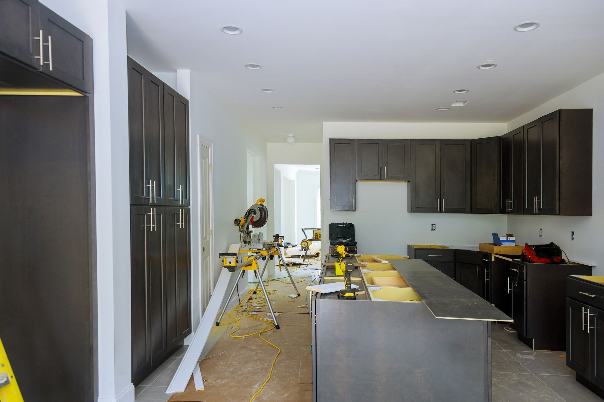 A kitchen under construction with a lot of cabinets and a large island.
