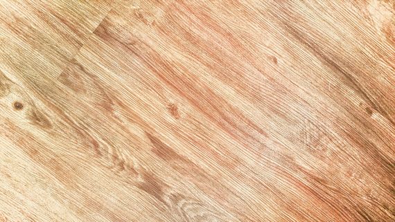 A close up of a wooden surface with a diagonal pattern.