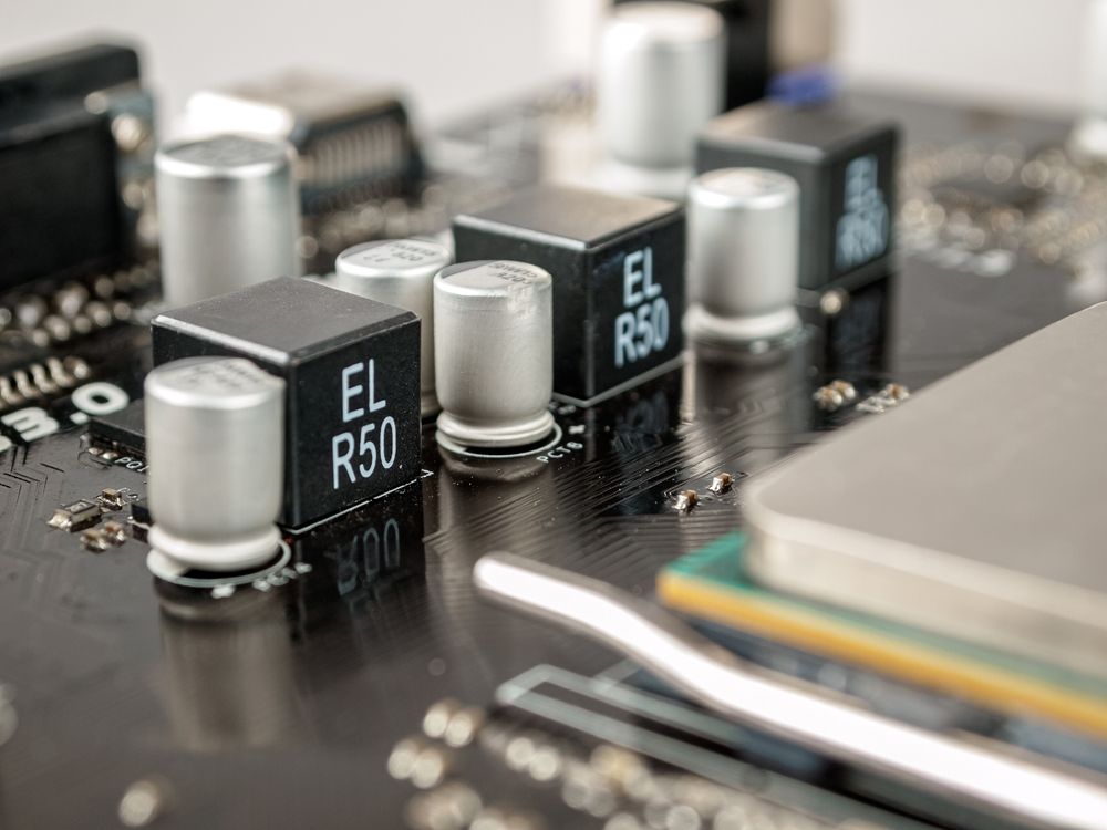A close up of a motherboard with a lot of electronic components on it.
