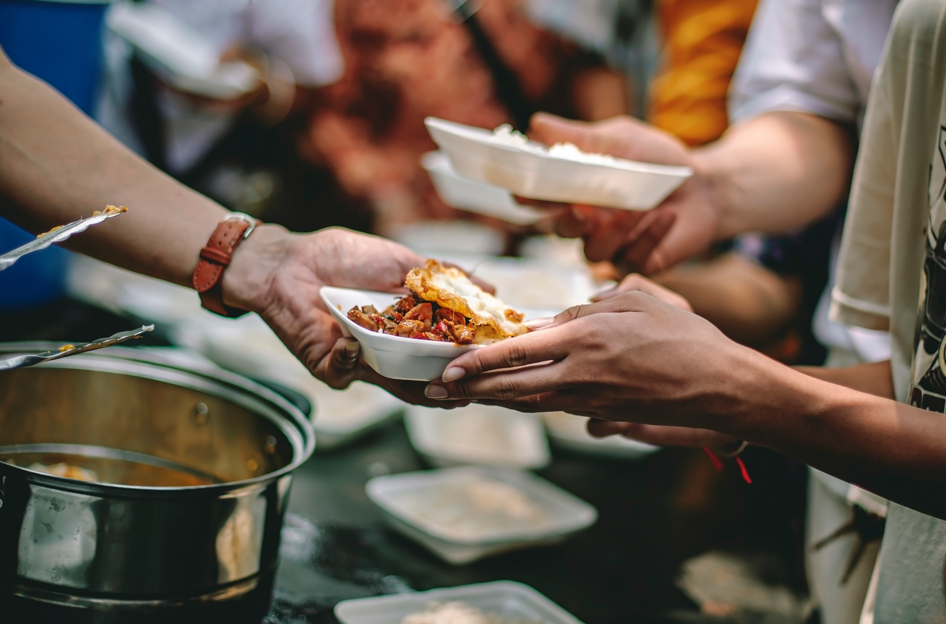 A group of people are giving food to each other.