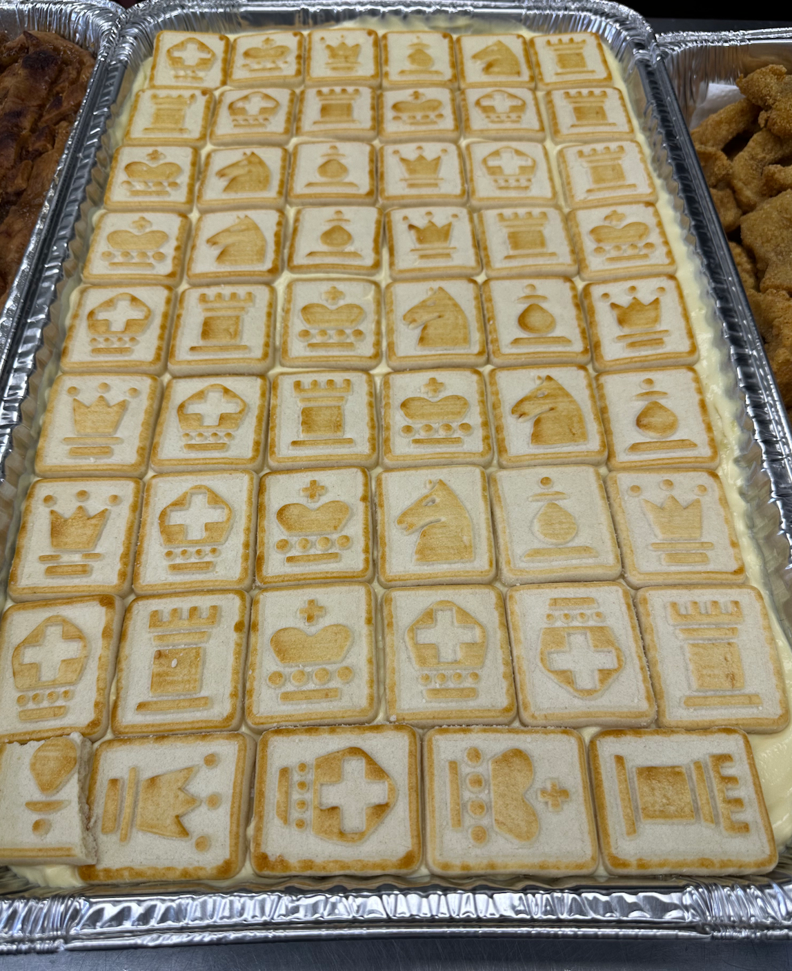 A tray of cookies with chess pieces on them