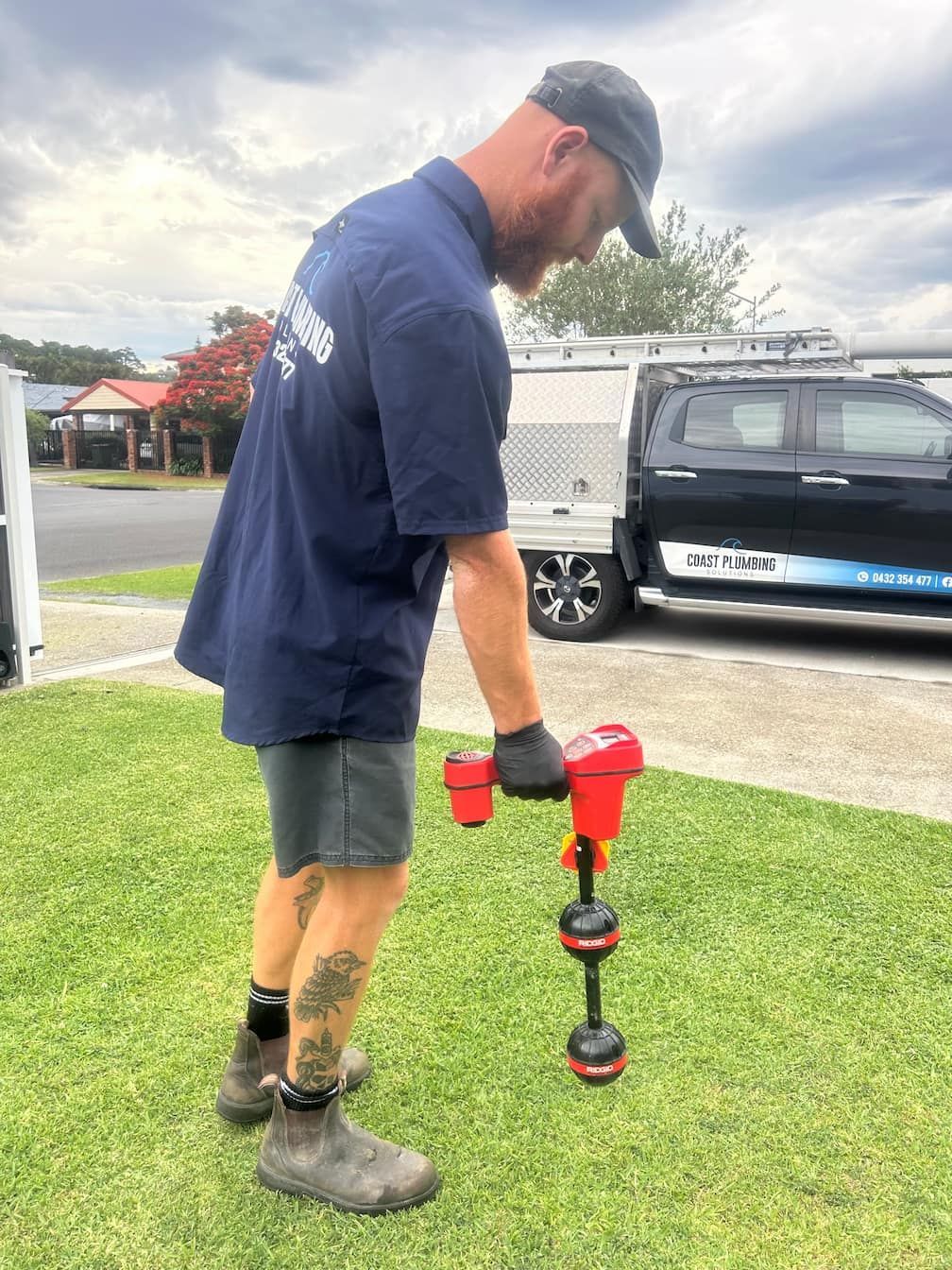 Person plunging a kitchen sink filled with water.