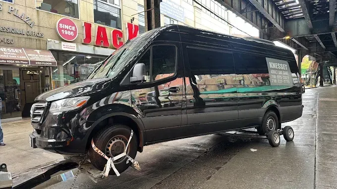 A black van is parked on the side of the road.