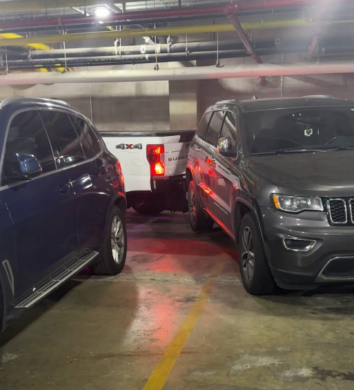 A black ford expedition is parked in front of a building.