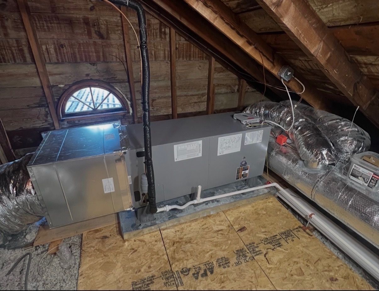 An open metal furnace cabinet showing internal wiring, a control board, gas piping, and three circular burner heads.
