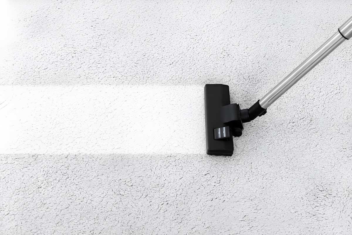 Removing Dirt From Soft Carpet With Vacuum Cleaner Indoors — Dryology Carpet Cleaning in Rutherford, NSW