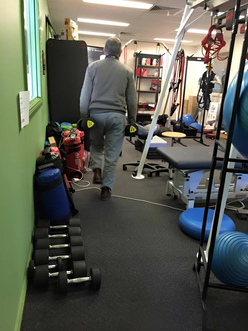 A Man Cleaning The Carpet On The Gym — Dryology Carpet Cleaning in Cessnock, NSW