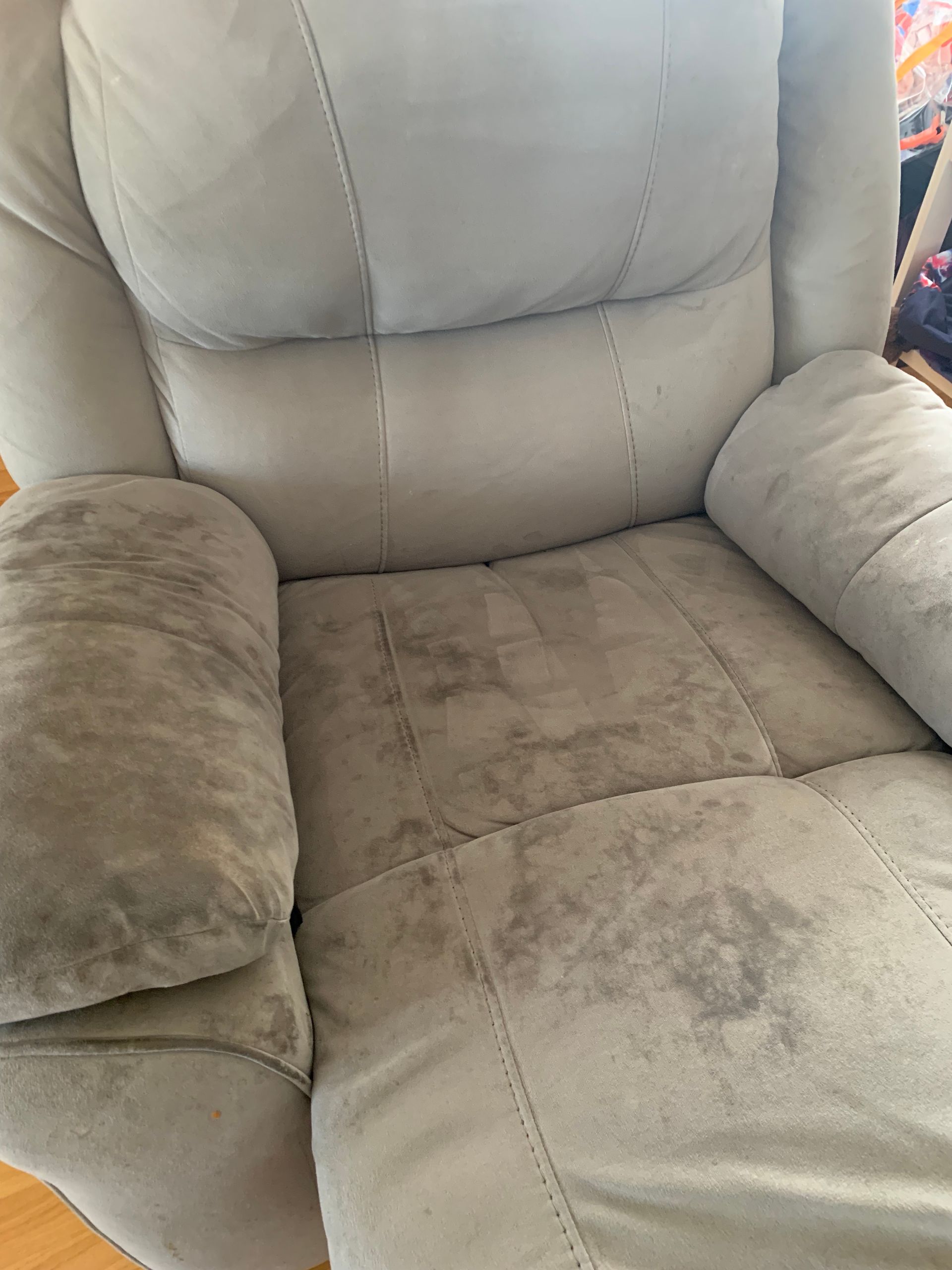 Gray recliner with wear marks on the seat and armrests — Dryology Carpet Cleaning in Salamander Bay, NSW