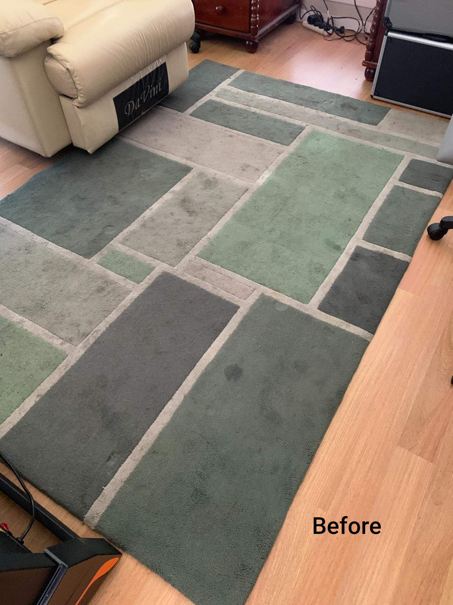 A before shot of a rectangular geometric rug on a wooden floor — Dryology Carpet Cleaning in Salamander Bay, NSW