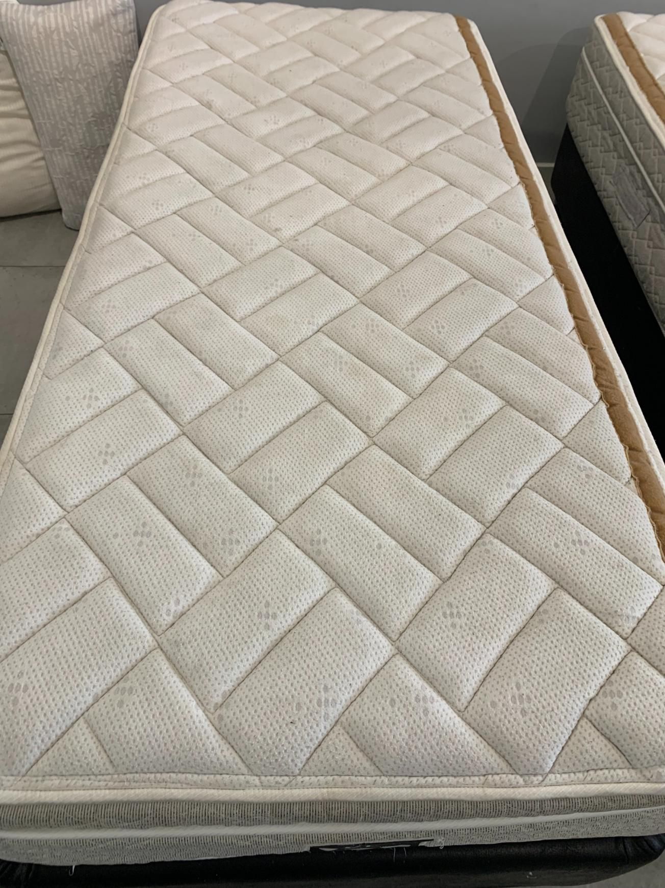 Tan quilted twin mattress next to a black mattress — Dryology Carpet Cleaning in Salamander Bay, NSW