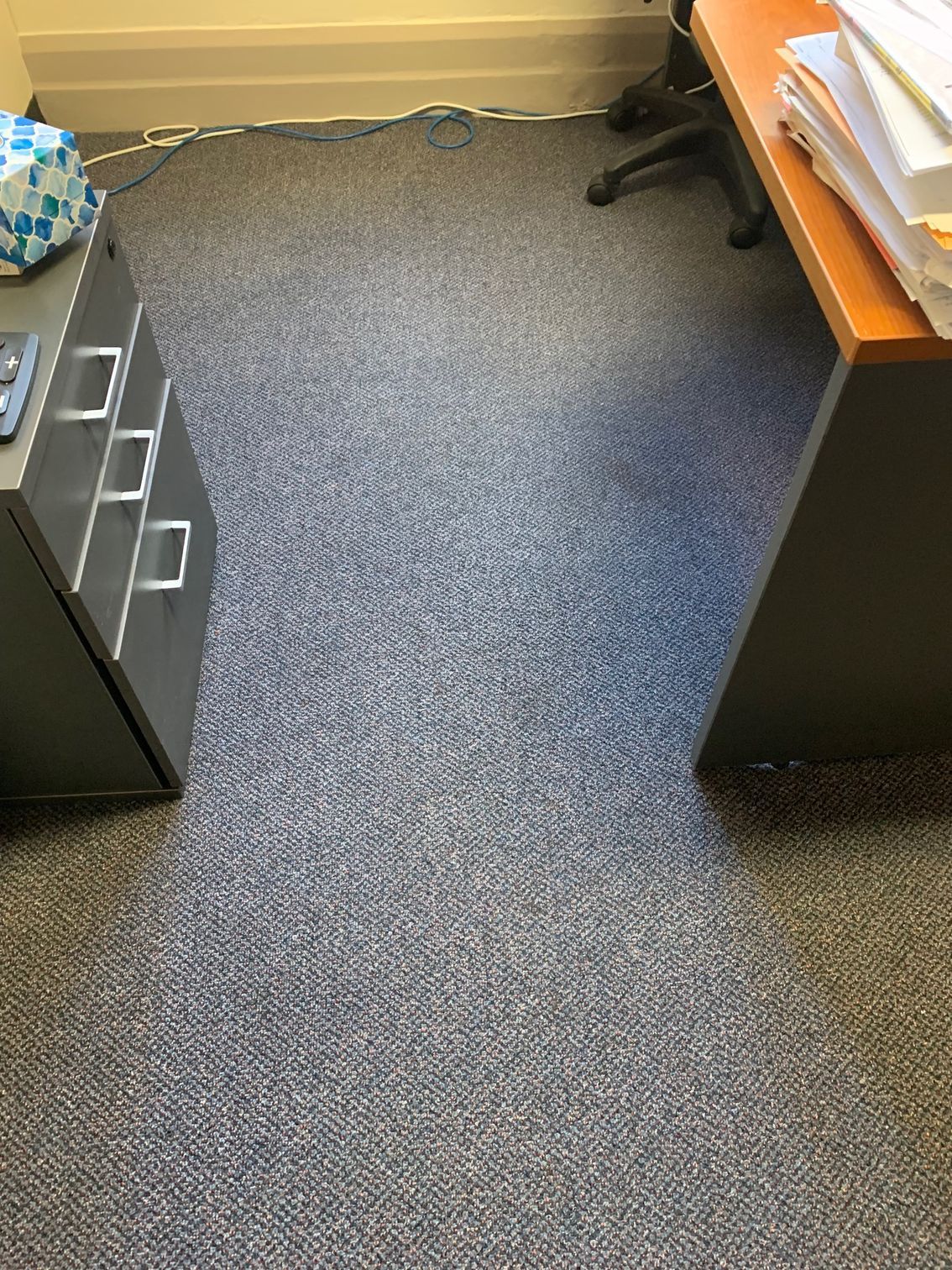 Gray and blue speckled office carpet beneath a desk and file cabinet — Dryology Carpet Cleaning in Salamander Bay, NSW