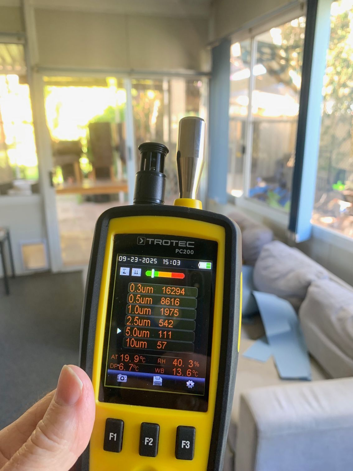 A Man Wearing a Mask and Gloves is Plugging a Plug Into a Wall — Dryology Carpet Cleaning in Salamander Bay, NSW
