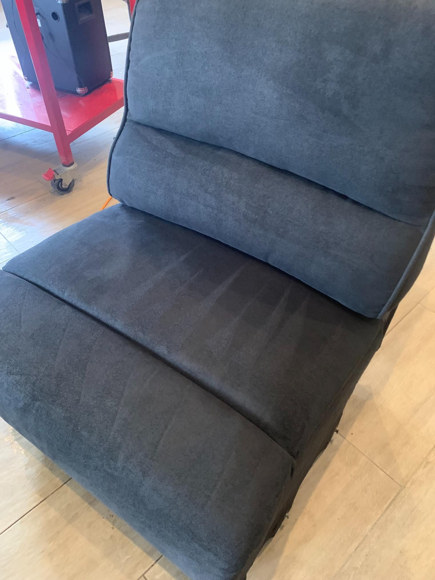 Dark gray upholstered floor chair with a segmented back and seat — Dryology Carpet Cleaning in Salamander Bay, NSW