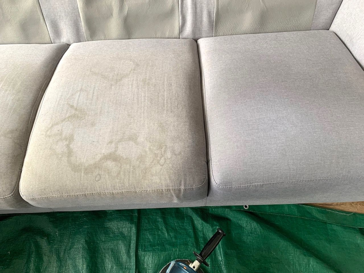 Person in Blue Gloves Cleaning a Beige Sofa — Dryology Carpet Cleaning in Salamander Bay, NSW
