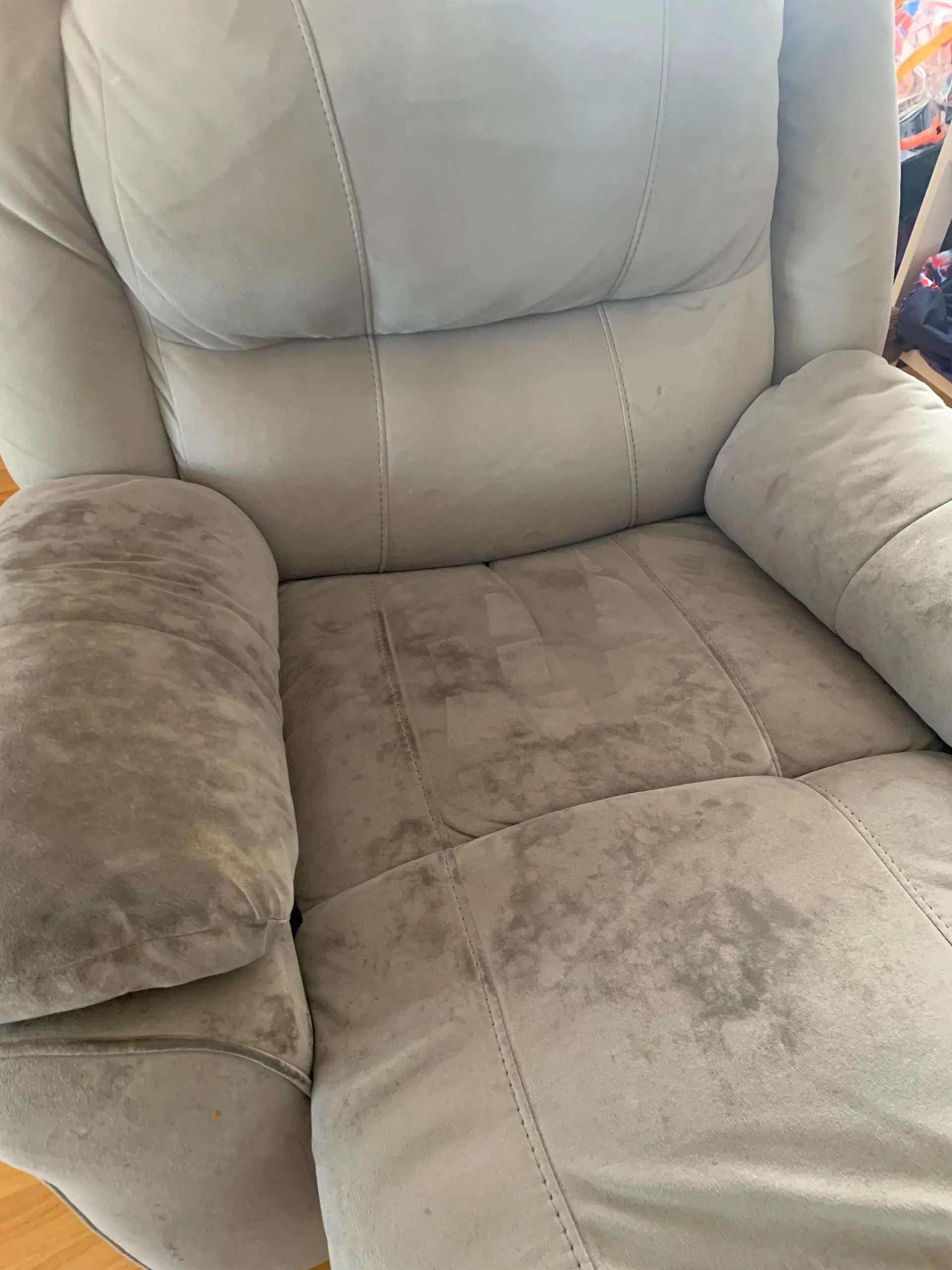 Gray Recliner Chair With Visible Stains on the Seat and Armrests — Dryology Carpet Cleaning in Nelson Bay, NSW