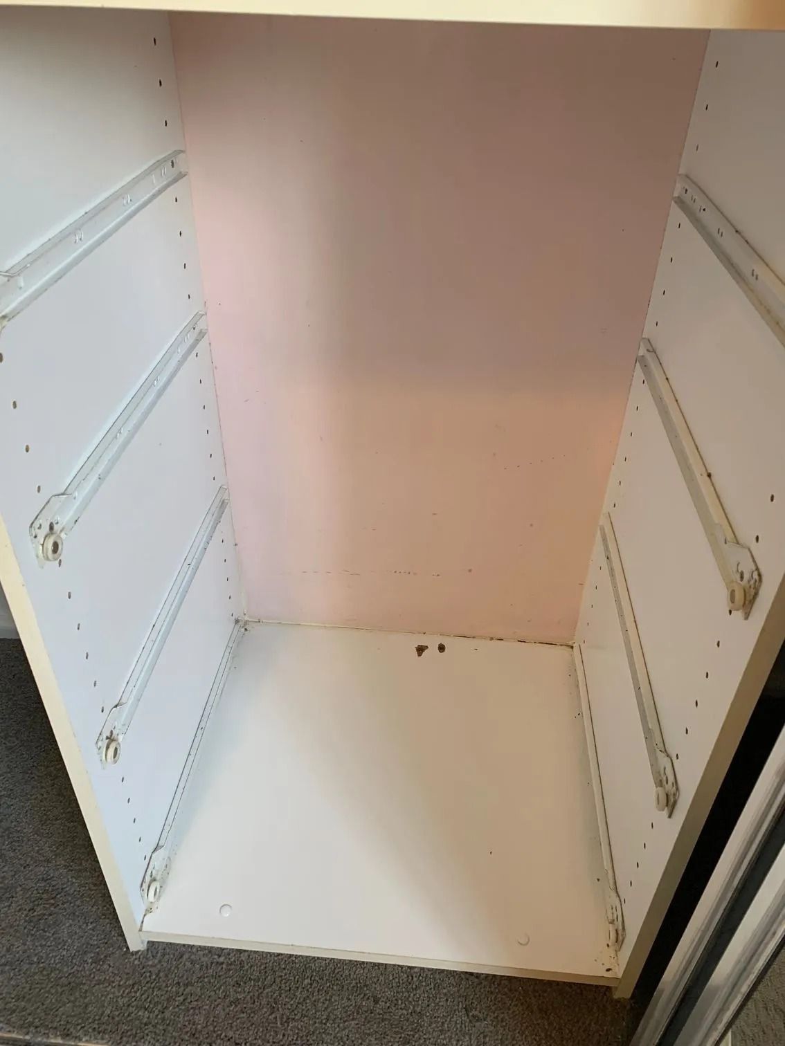 Empty Cabinet Interior With Drawer Slides, Pink Back Panel, White Shelves — Dryology Carpet Cleaning in Lake Macquarie, NSW