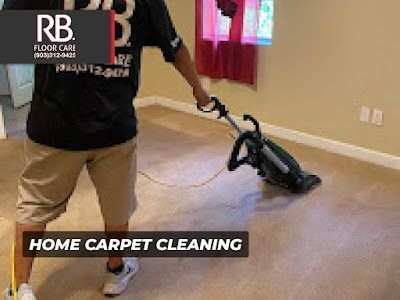 Man cleaning carpet in a room with a professional vacuum cleaner, home carpet cleaning service.