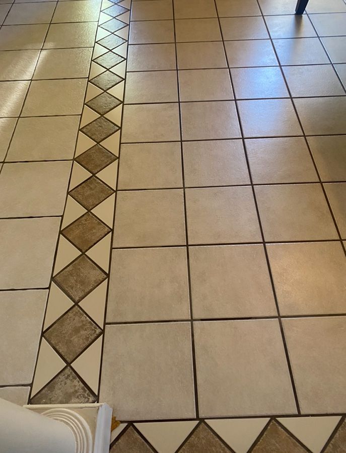 Beige tiled floor with a diamond pattern border.