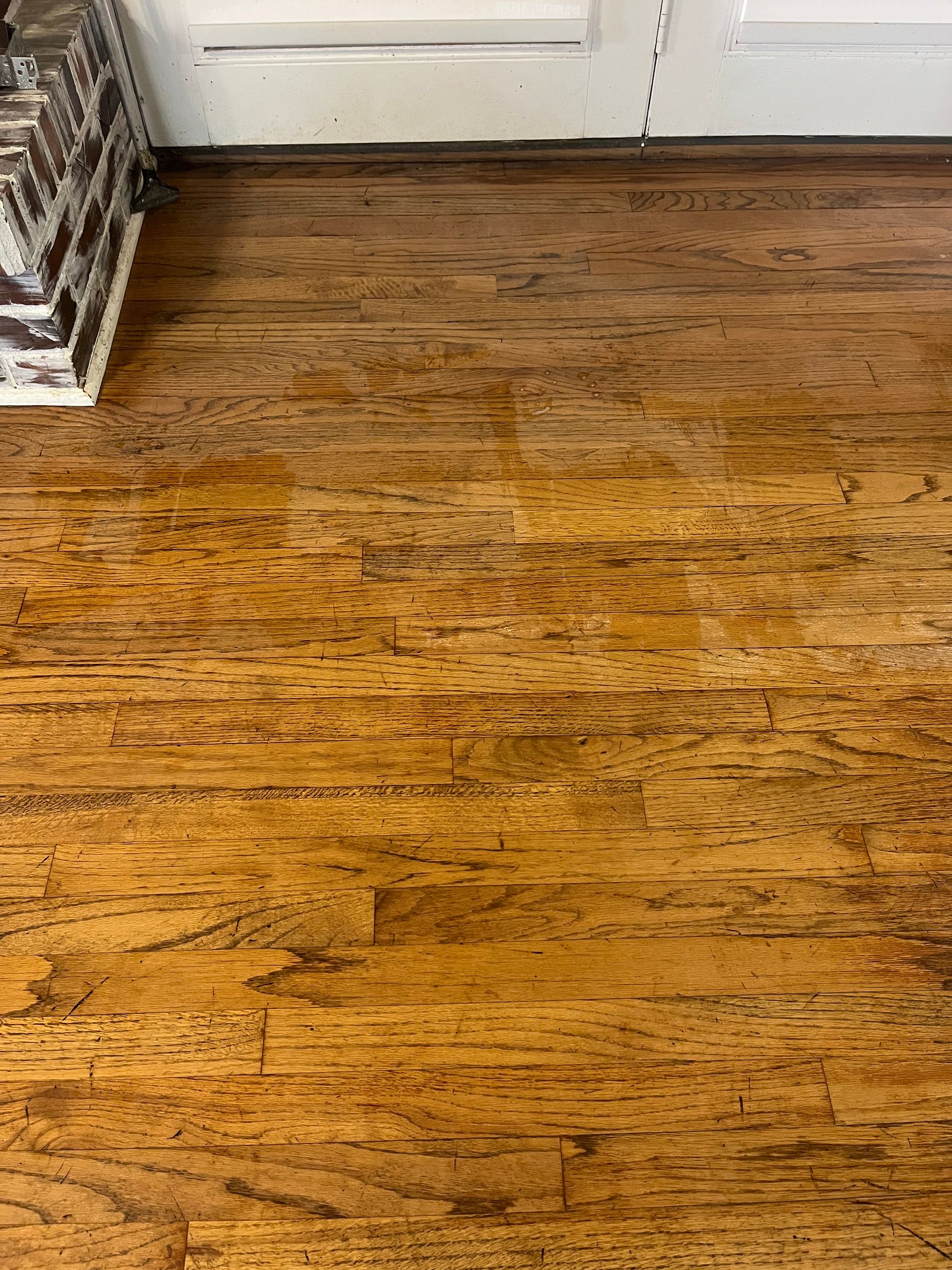Hardwood floor with varying brown and gold tones.