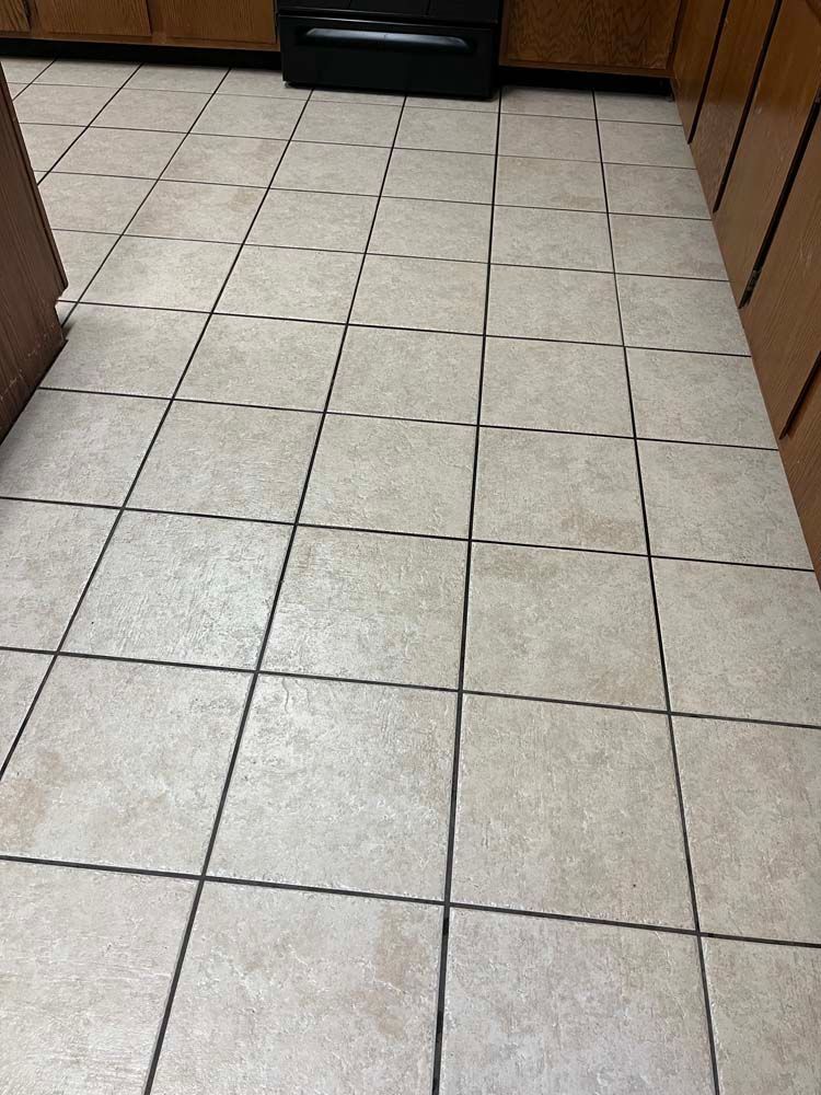 Tan tiled kitchen floor.