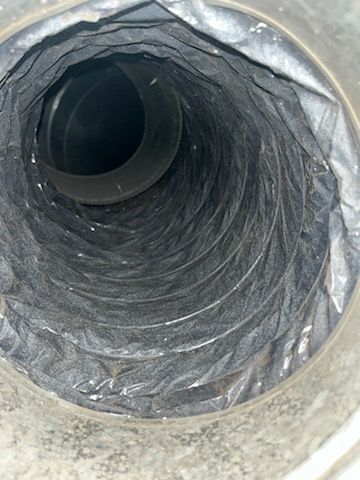 Inside view of a flexible silver HVAC duct.