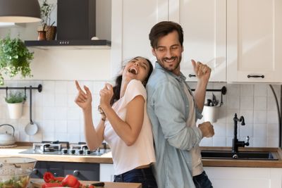 Couple Laughing In Kitchen