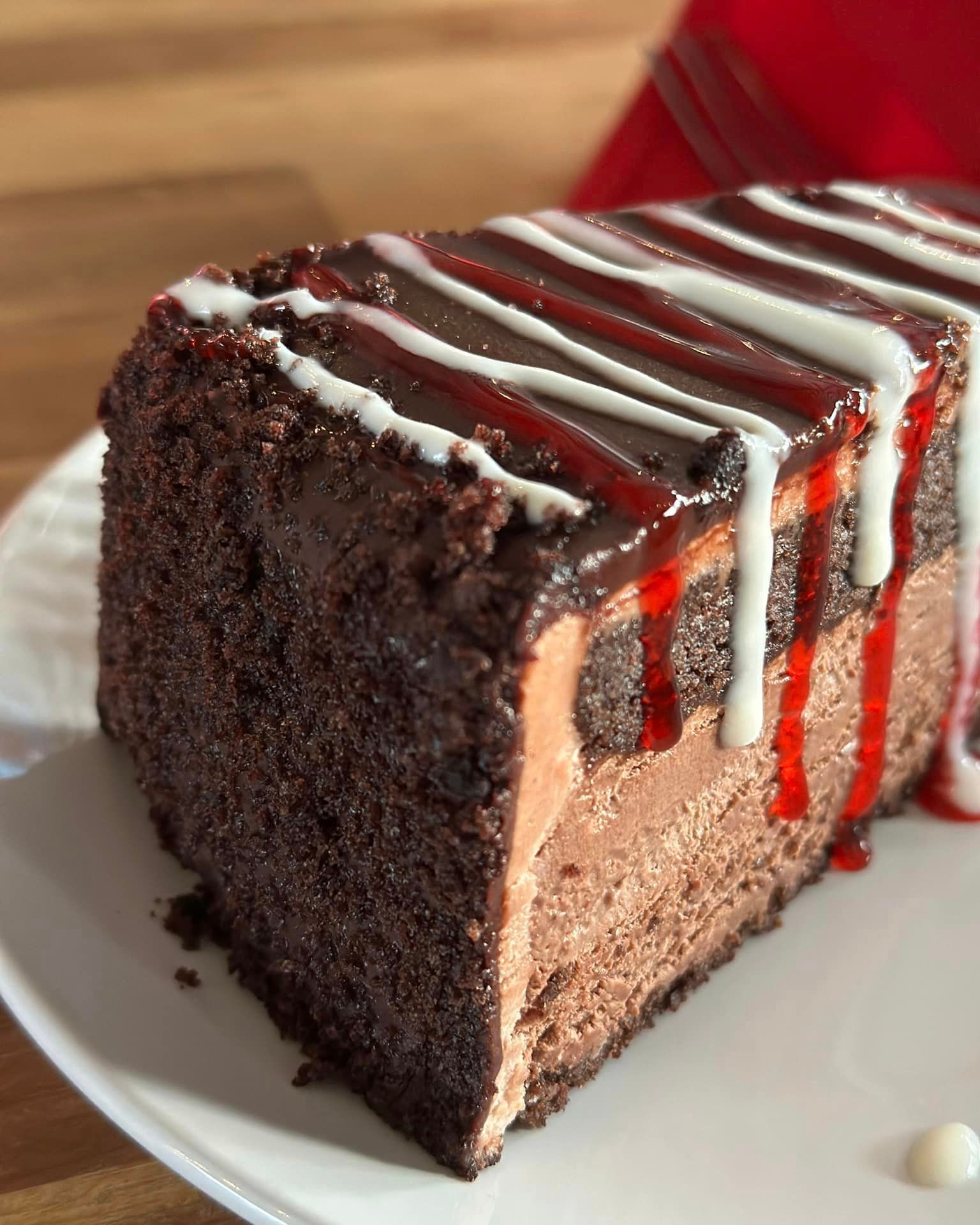A slice of chocolate cake on a white plate