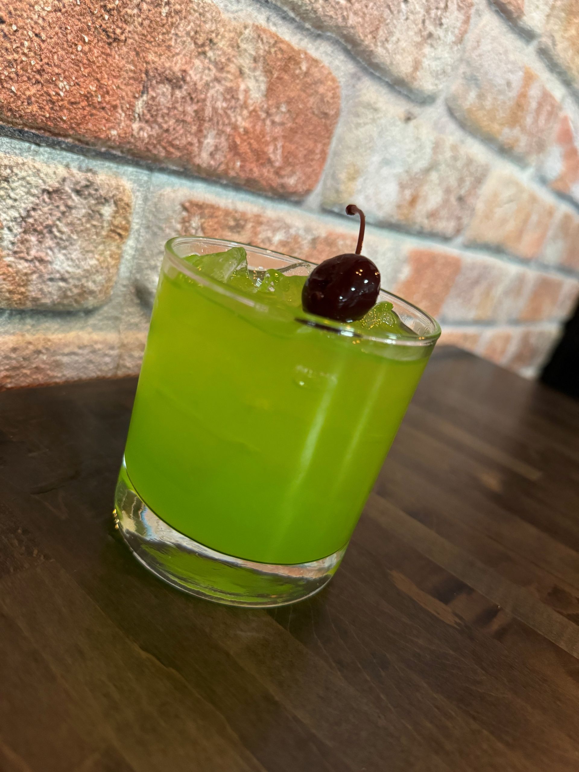 A tray of shot glasses filled with different colored liquids