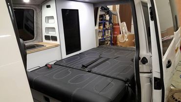 inside of a van with lowered seating to make a bed base