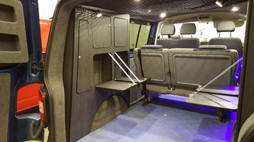 inside a converted vehicle with drop down cupboards