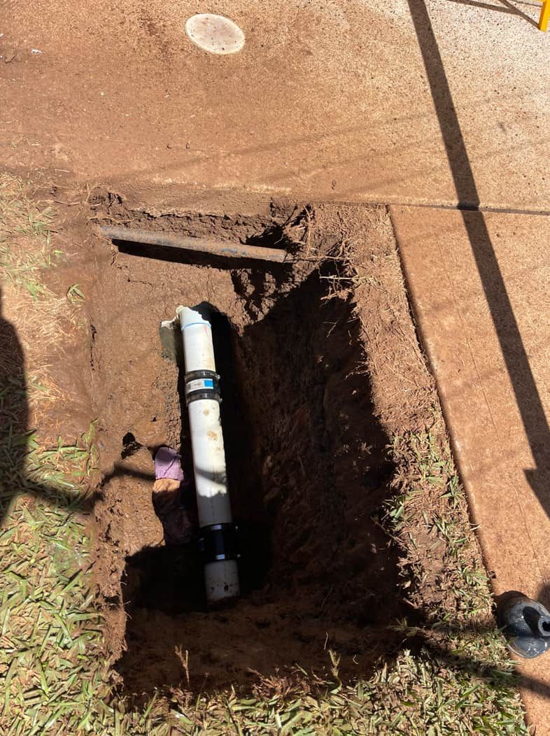 A Pipe Is Being Installed In A Hole In The Ground — Panorama Plumbing In Dubbo, NSW