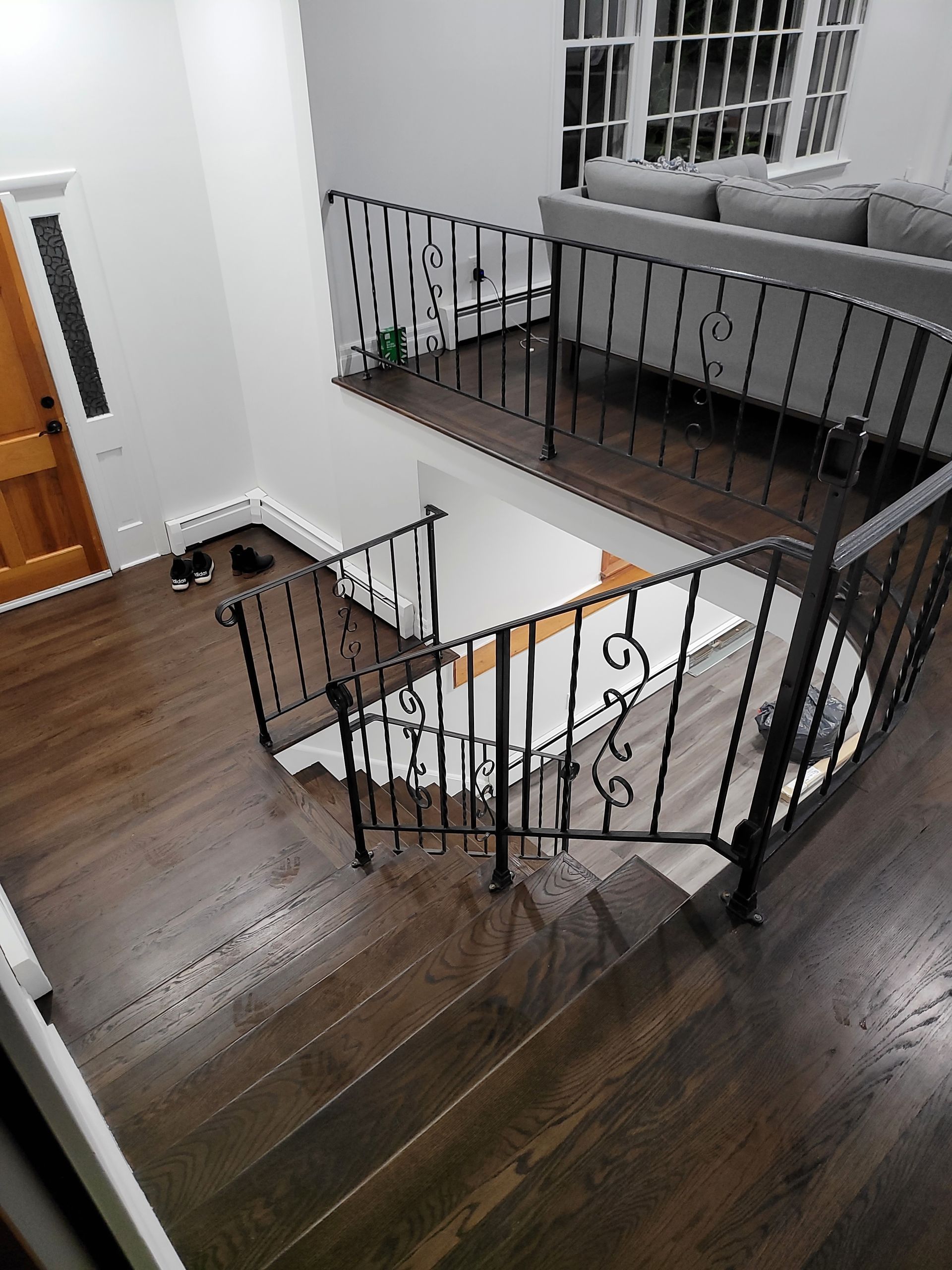 A staircase in a house with a wrought iron railing