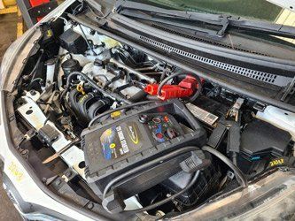 The engine of a car is shown with the hood open.