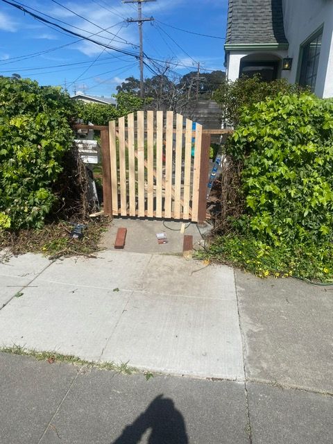 A wooden gate is being built in front of a house