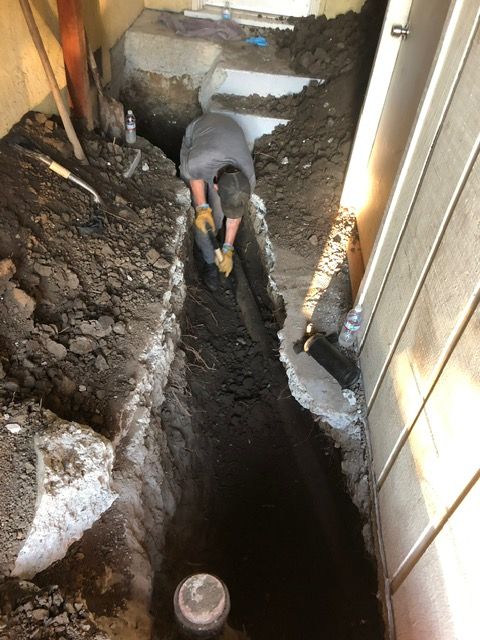 A man is digging a hole in the ground