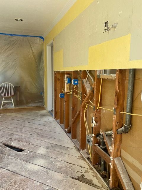 A room with a wooden floor and a chair in it