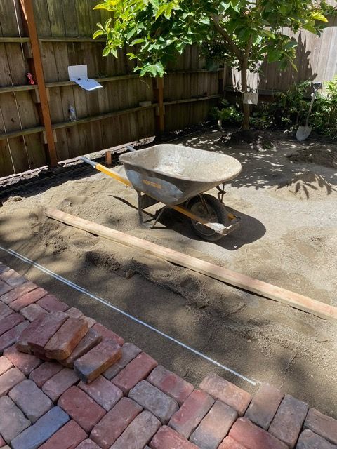 A wheelbarrow is sitting on top of a pile of dirt