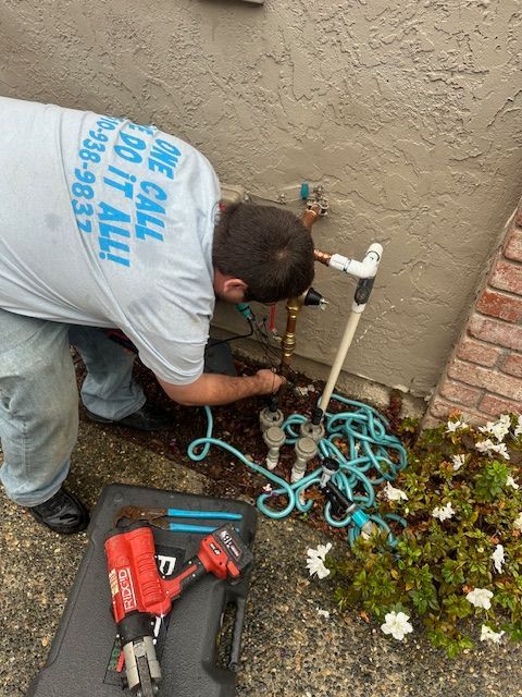 A man wearing a shirt that says one call do it all