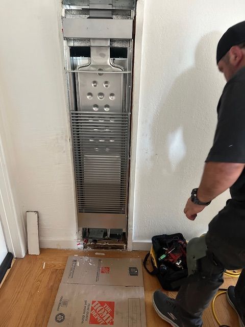 A man is standing next to a box that says the home depot on it.