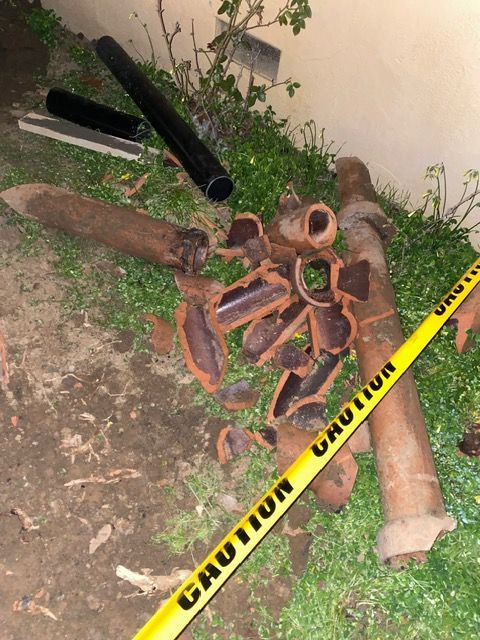 A yellow caution tape is laying on the ground