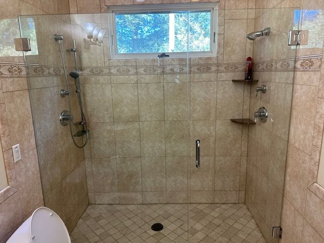A bathroom with a walk in shower and a toilet