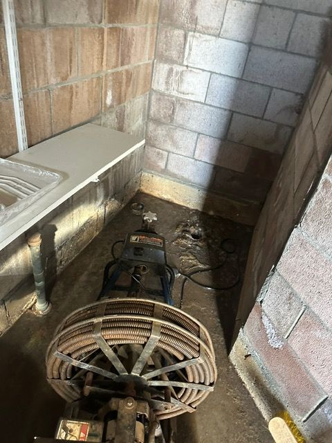 A machine is sitting in a room next to a sink.