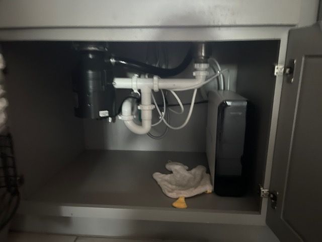 A sink with a plumbing pipe underneath it