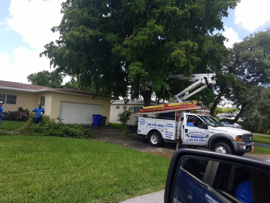 A white truck is parked in front of a house.