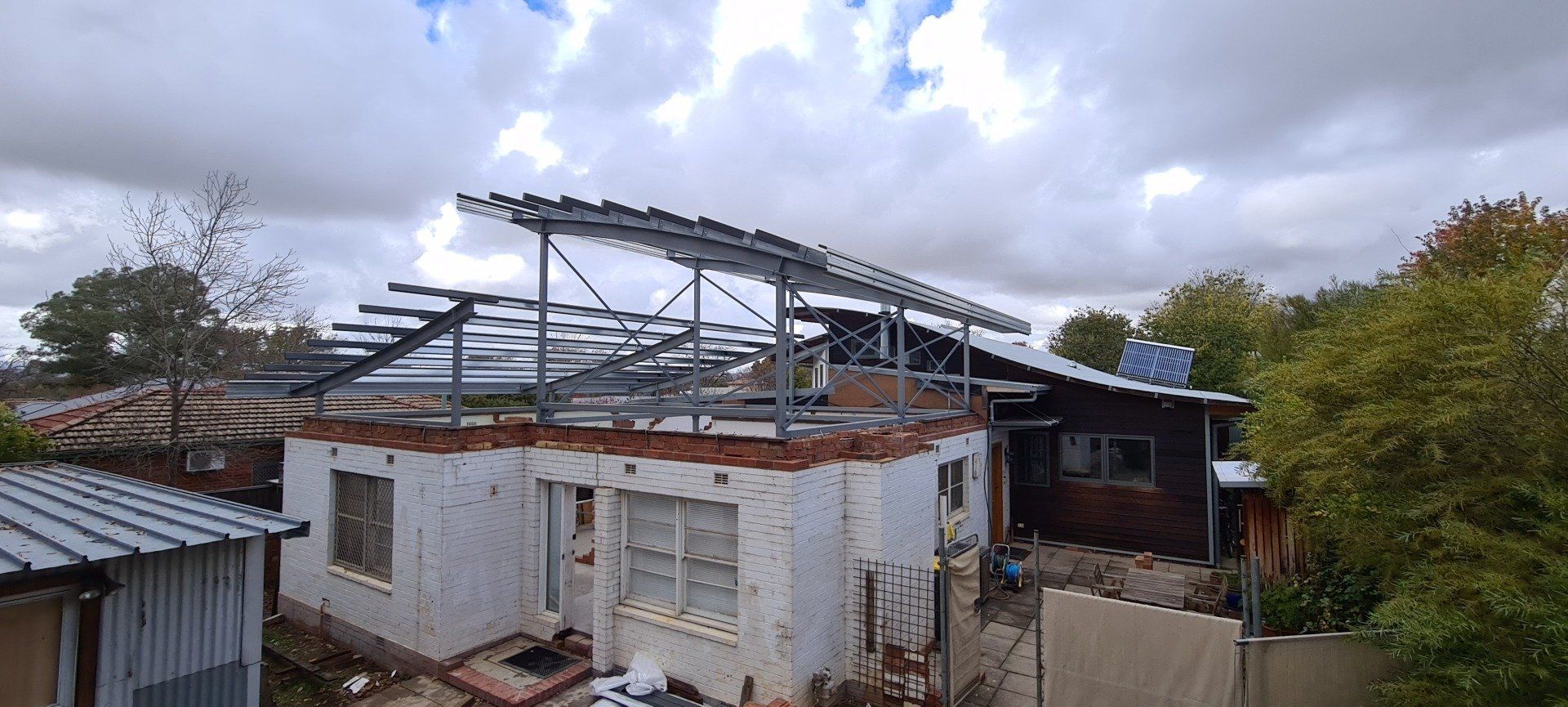 A house is being built with a metal roof.