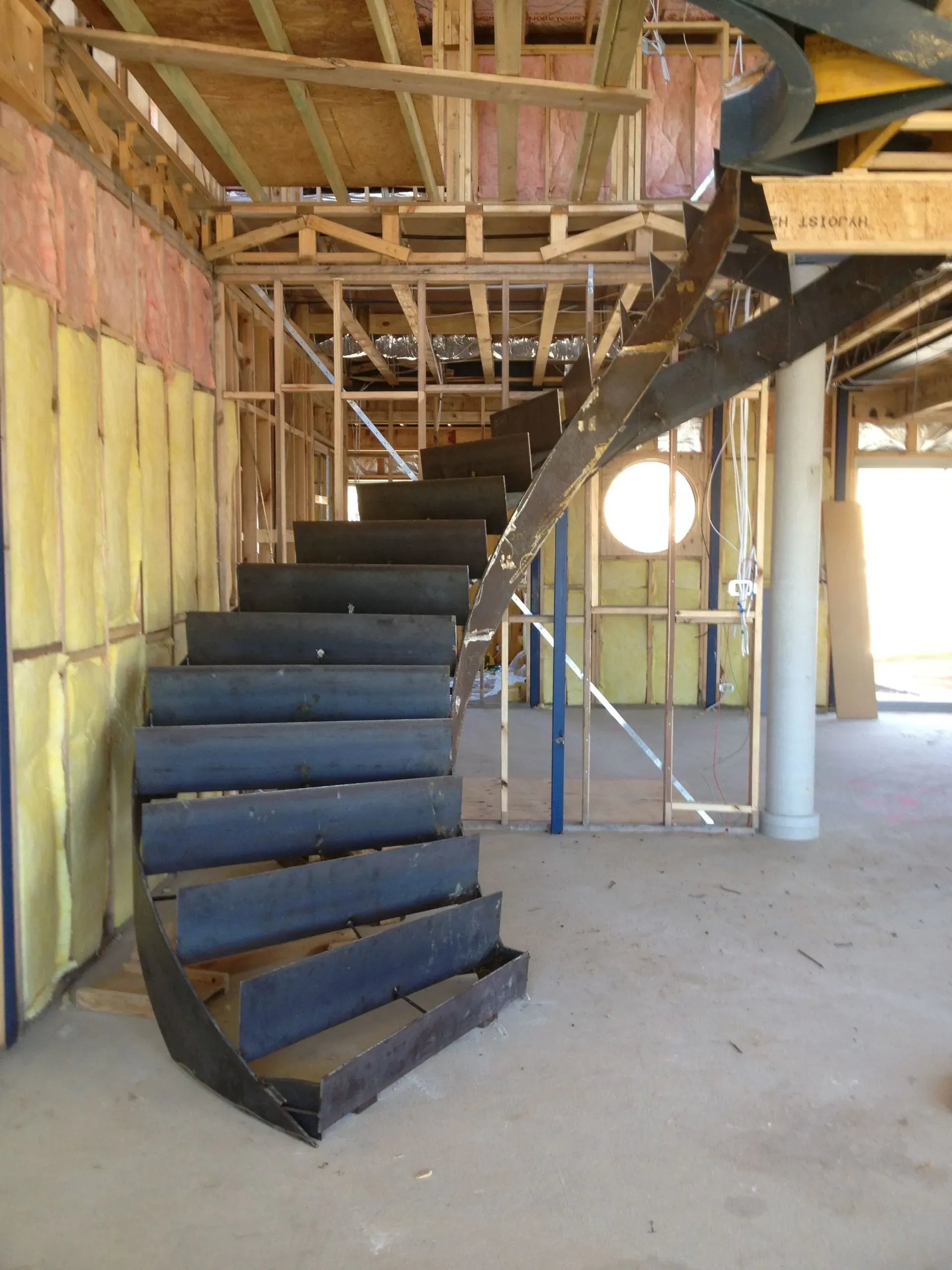 A spiral staircase in a building under construction